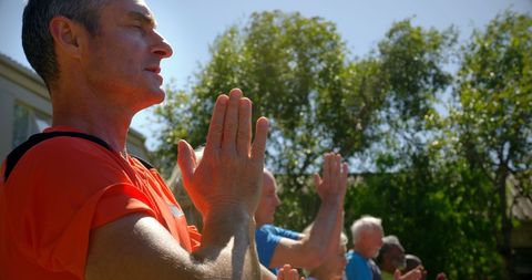 Yoga Instructor Leading Senior Group Session Outdoors