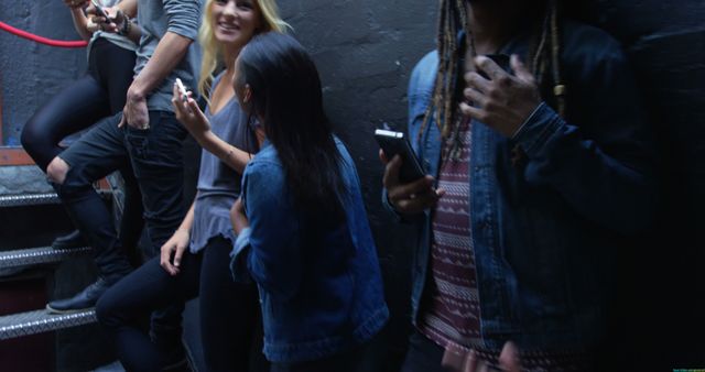 Diverse Friends Using Smartphones on Pub Stairs - Download Free Stock Images Pikwizard.com