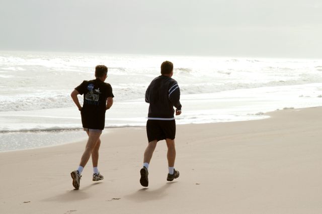 KENNEDY SPACE CENTER, FLA. - Congressman Tom Feeney (right) jogs along the beach at Kennedy Space Center.  Accompanying him is Ricky D. O’Quinn, a member of the KSC SWAT team.  During January and February, Congressman Feeney traveled the entire coastline of Florida’s 24th District, and concluded his walks March 1 in Brevard County.  On his walks, he met with constituents and community leaders to discuss legislative issues that will be addressed by the 108th Congress.