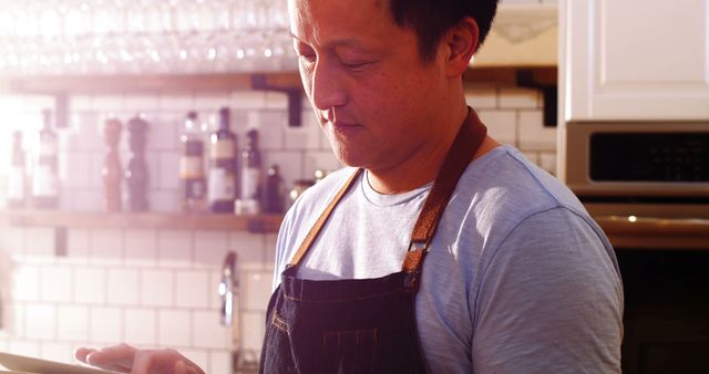 Asian Chef Using Tablet in Modern Kitchen - Download Free Stock Images Pikwizard.com