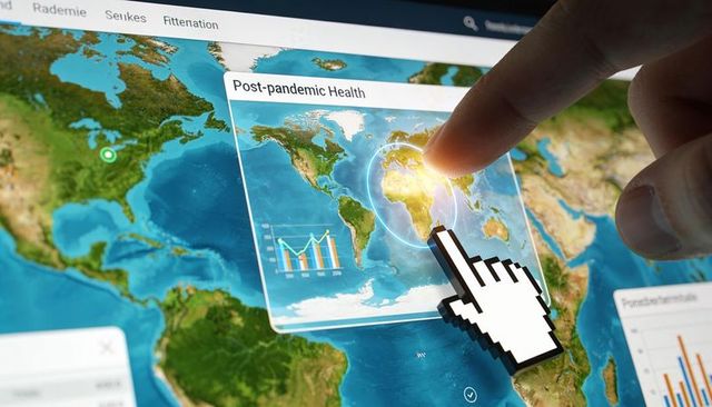 Tapping touchscreen world map showing post-pandemic health dashboard and data analytics