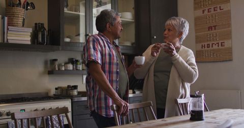 Senior Couple Relaxing with Coffee in Cozy Kitchen Setting