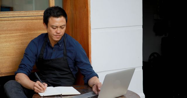 Focused Male Barista Working on Business Plans with Laptop - Download Free Stock Images Pikwizard.com