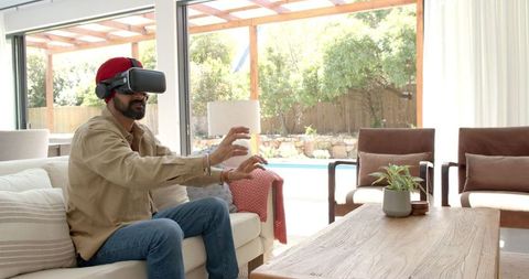 Man Engaging with Virtual Reality Headset in Modern Living Room
