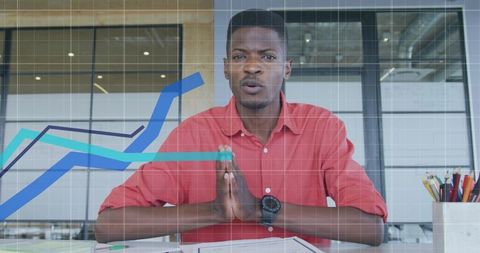 Focused business analysis with digital chart overlay in modern office