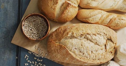 Variety of Artisan Loaves on Rustic Table with Sunflower Seeds