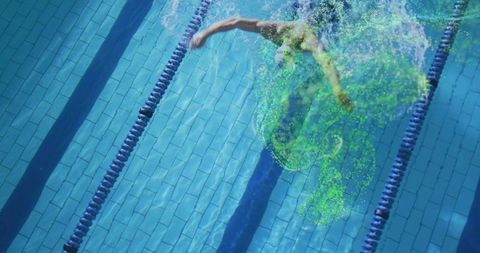 Male swimmer gliding through lap pool leaving neon green dye trail, dynamic water swirl