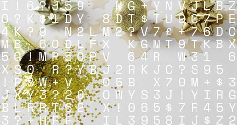 Spilling gold confetti with metallic bows, ribbons and star cutouts flatlay background