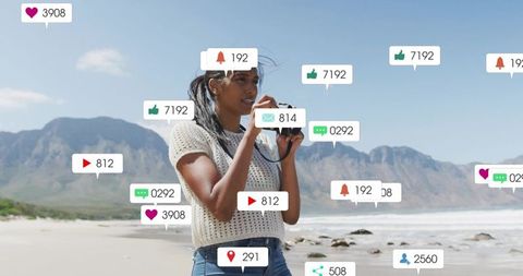 Woman shooting on sunny beach with floating social media notifications and icons