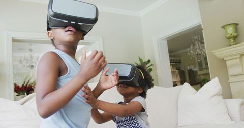 Joyful African American Girls Experiencing Virtual Reality at Home