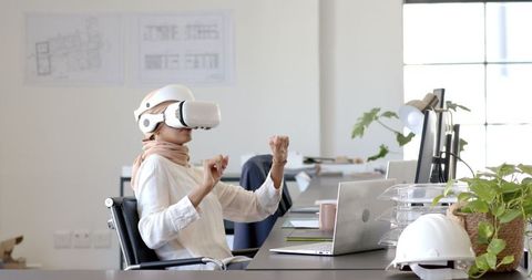 Businesswoman Engaging with VR Headset in Modern Workspace