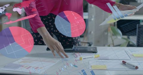 Businesswoman Analyzing Data with Digital Graphs and Blueprints