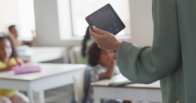 Teacher Using Tablet in Classroom with Engaged Students - Download Free Stock Images Pikwizard.com