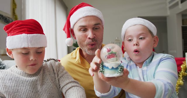 Excited Family Enjoying Christmas Snow Globe Together - Download Free Stock Images Pikwizard.com