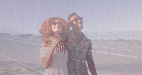 Smiling Couple on Coastal Road with Scenic Ocean View