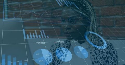 Businesswoman analyzing data with digital charts overlaid