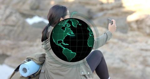 Adventurous Female Hiker Capturing Selfie by Rocky Shoreline