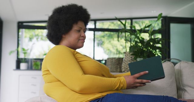 Smiling African American Woman Reading on Digital Tablet at Home - Download Free Stock Images Pikwizard.com