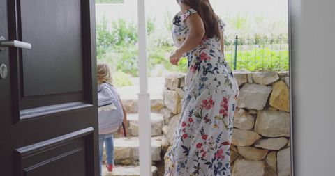 Mother Accompanies Child to School from Home Entrance