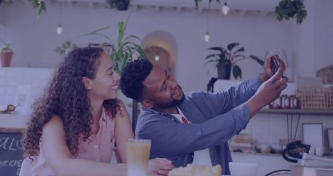 Smiling Couple Sharing Relaxed Moments in Cozy Café Setting