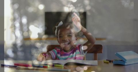 Joyful African American Girl Studying with Pencils and Book at Home