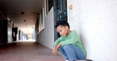 Upset Boy Sitting on School Ground Exhibiting Loneliness - Download Free Stock Images Pikwizard.com