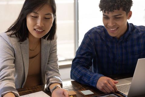 Diverse Coworkers Collaborating in Business Firm Workspace
