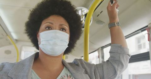 Biracial Woman Wearing Mask Traveling by Bus During Pandemic - Download Free Stock Images Pikwizard.com
