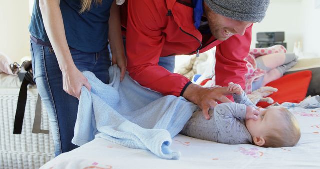 Young Parents Changing Baby's Diaper at Home - Download Free Stock Images Pikwizard.com