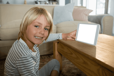 smiling child presenting tablet with transparent screen indoors - Download Free Stock Videos Pikwizard.com