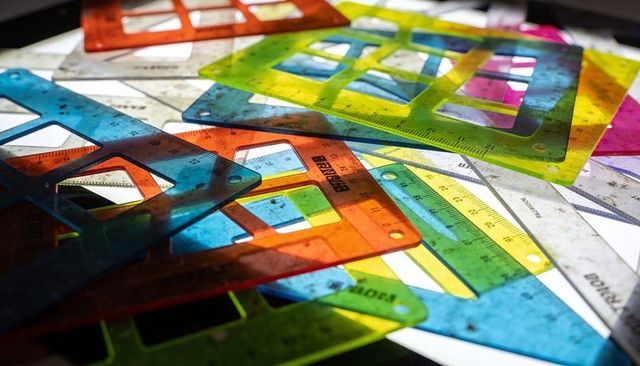 Colorful translucent drafting templates overlapping, casting shadows and revealing rulers