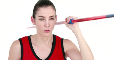 Female athlete holding javelin with focused pose