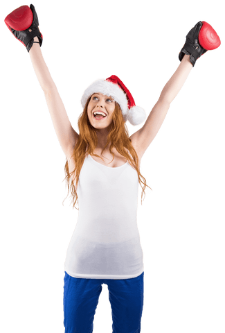 Joyful Female Boxer Wearing Santa Hat with Raised Arms Transparent