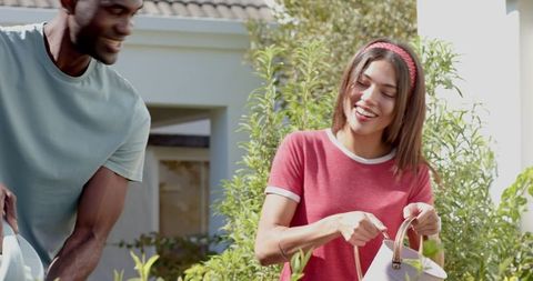 Smiling Couple Engaged in Home Gardening at Front Yard
