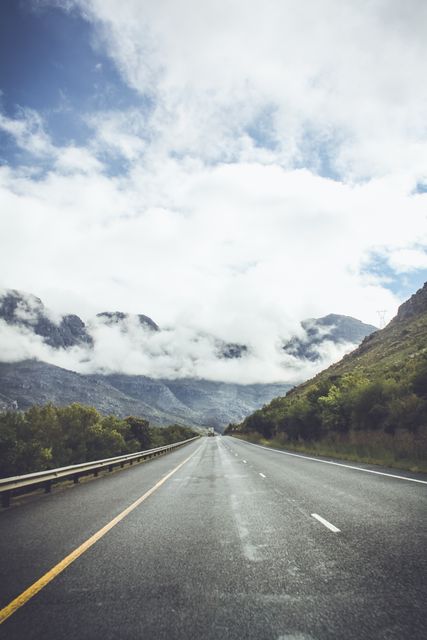 Scenic Mountain Highway Under Cloudy Sky - Download Free Stock Images Pikwizard.com