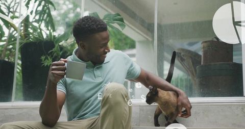 Relaxed Man with Cat and Mug Amidst Floating Financial Symbols
