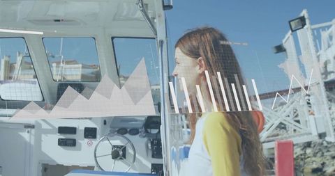 Teenage girl peering into boat helm with augmented digital charts overlay at sunny marina harbor