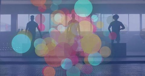 Trio Practicing Workout Moves in Gym with Artistic Bokeh Overlay