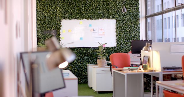 Interior of casual office with computers on desks, chairs and whiteboard. Casual business, interior and office.