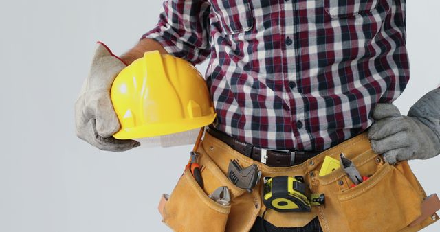 Construction Worker with Tool Belt and Hard Hat in Hand - Download Free Stock Images Pikwizard.com