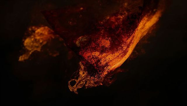 Dynamic orange-red smoke plume in dark studio