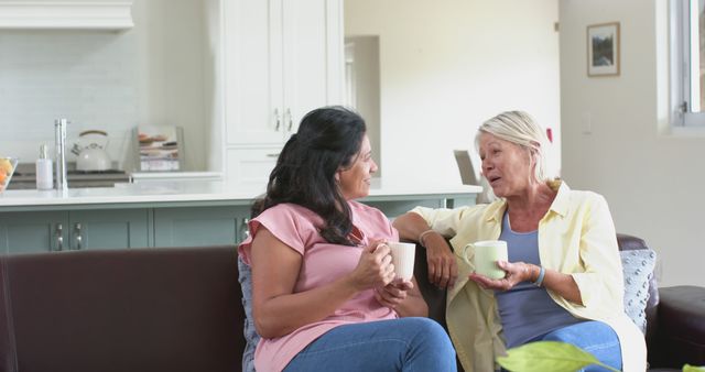 Senior Woman and Adult Daughter Having Coffee Together in Living Room - Download Free Stock Images Pikwizard.com