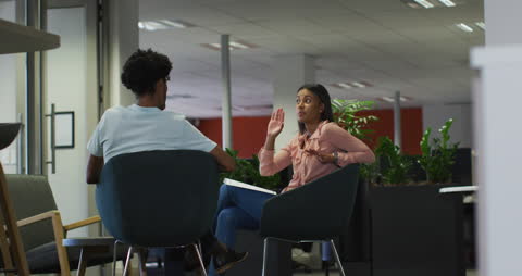 Colleagues Engaged in Discussion in Modern Office