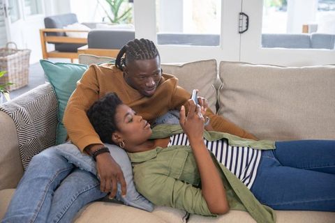 Couple Relaxing with Smartphone at Home