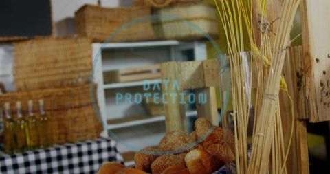 Rustic bakery stall displaying sesame rolls with baskets and olive oil bottles
