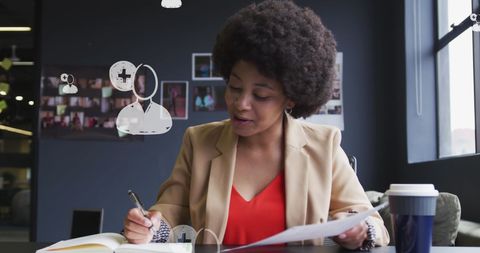 Smiling african american businesswoman using media icons for communication
