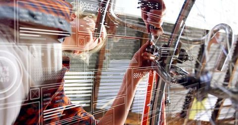 Female bicycle mechanic using ar technology in repair workshop