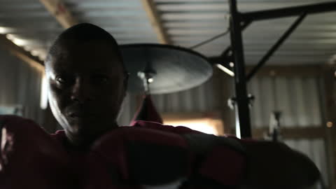 Focused Athlete Boxing in Intense Gym Environment