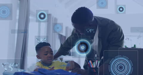 Father and Son Engaged with Homework and Technology Overlays