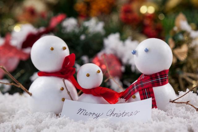 Festive Snowman Family with Merry Christmas Sign - Download Free Stock Photos Pikwizard.com
